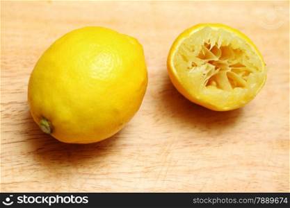 Lemon fruits fresh and half queezed on old wooden table kitchen cutting desk board background. Healthy food organic nutrition