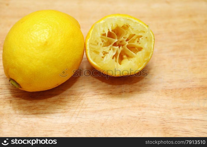 Lemon fruits fresh and half queezed on old wooden table kitchen cutting desk board background. Healthy food organic nutrition