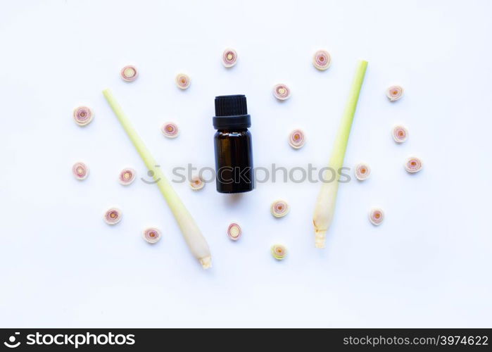 Lemon grass essential oil with sliced fresh Lemon grass on white