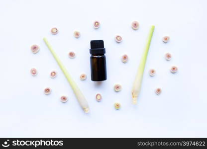 Lemon grass essential oil with sliced fresh Lemon grass on white