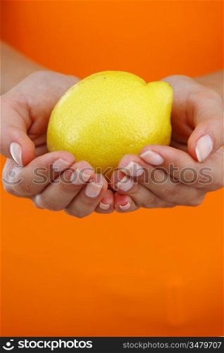 lemon in woman hands close up