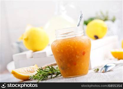 lemon jam in glass jar and on a table