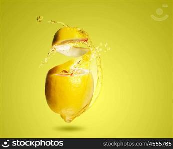 Lemon juice. Image of refreshing lemon cocktail with juicy splashes