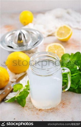 lemon juice in glass and on a table