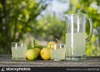 lemon juice on a wooden table, autumn set, outdoor. lemon juice