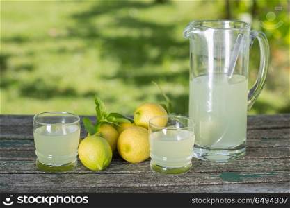 lemon juice on a wooden table, autumn set, outdoor. lemon juice
