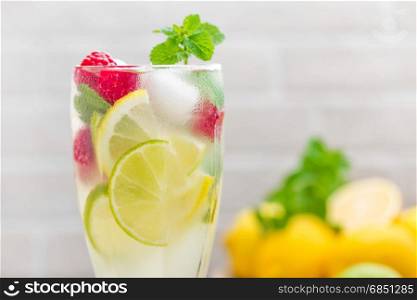 Lemon mojito cocktail with lime mint and raspberry cold drink with ice.