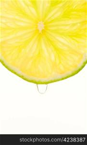 Lemon slice and juicy drop, white isolated background.