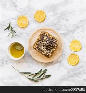 lemon slice twig with honeycomb bowl oil white marble background