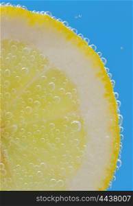 Lemon Slices deeply under water and bubbles