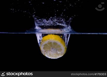 lemon splashing in pure water isolated on black background