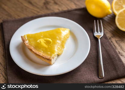 Lemon tart on the wooden background