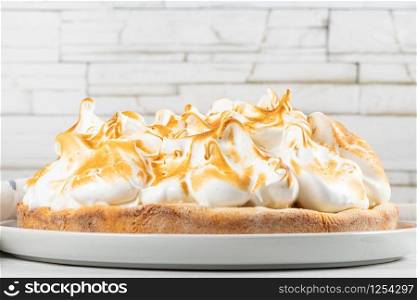 Lemon tart pie with meringue cream. Traditional American cake. Homemade baking. Copy space.