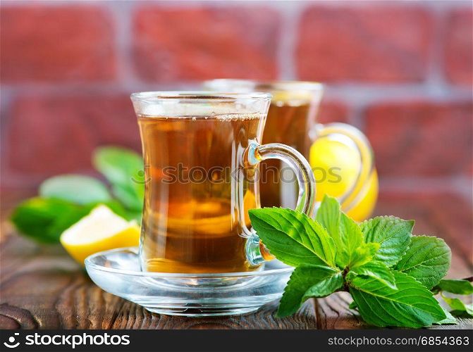 lemon tea in cup and on a table