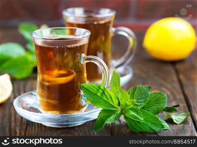 lemon tea in cup and on a table