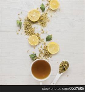 lemon tea with dried chinese chrysanthemum flowers lemon slices wooden table