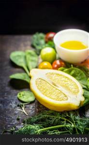 Lemon with fresh herbs, seasoning and dressing, ingredients for cooking on rustic wooden background