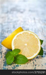 Lemon with mint on table background with copy space. Macro shot