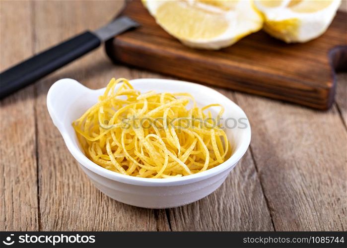 lemon zest on a woodwn background. lemon zest