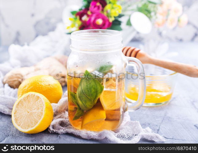 lemonad with fresh lemon and ginger on a table