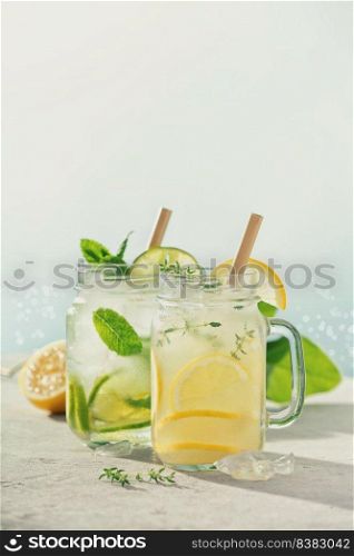 Lemonade and mojito close up. Summer cocktails with blur sea on background. Vacation concept. Lemonade and mojito close up. Summer cocktails with blur sea on background