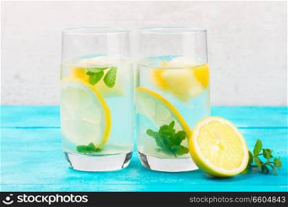 Lemonade homemade drink - two glasses with ice and mint. Lemonade homemade drink