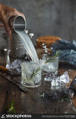 lemonade in glass with rosemary.