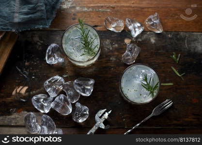 lemonade in glass with rosemary.  