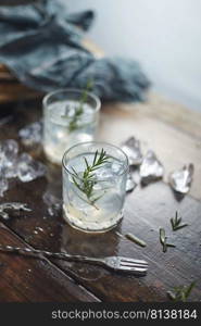 lemonade in glass with rosemary.  