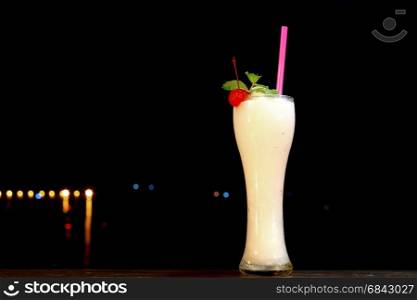 lemonade shake drink in glass with mint leaf and cherry on top