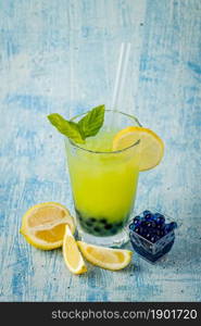 Lemonade with bubble tea on blue stone background