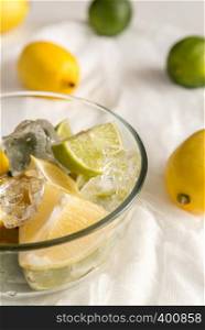 Lemons and limes on the white background