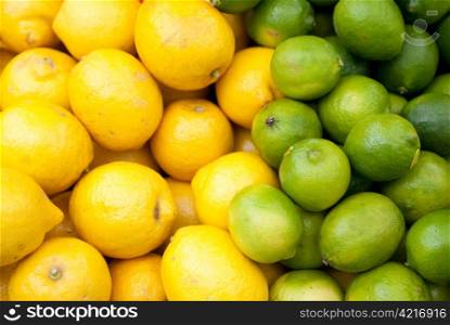 lemons and limes stacked up for sale on a market