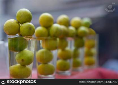 Lemons arranged in glass at stall