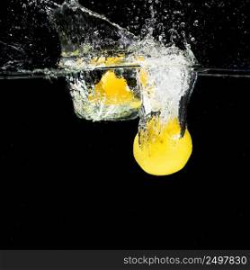 lemons falling into water splash