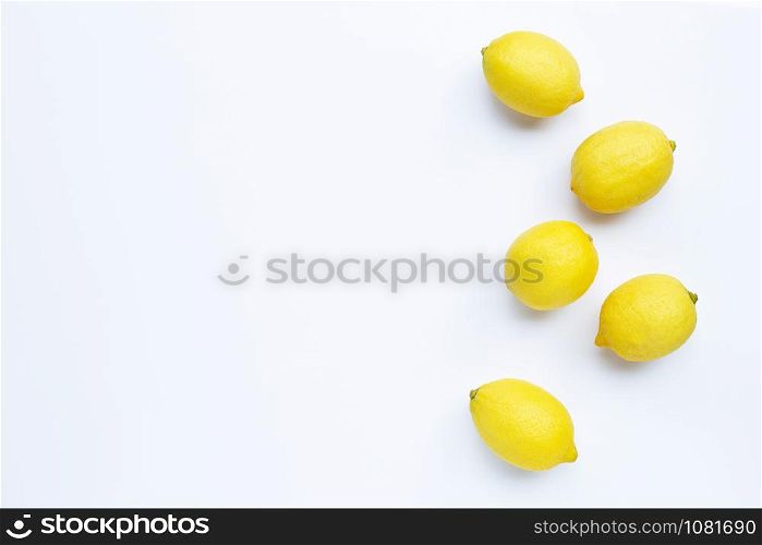 Lemons on white background. Top view with copy space