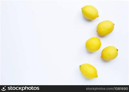 Lemons on white background. Top view with copy space
