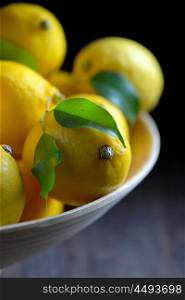 lemons with leaves on an old wooden table