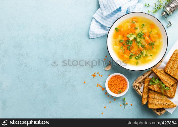 Lentil soup with vegetables and fresh parsley on plate