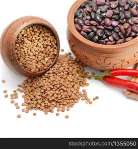 Lentils and beans in ceramic pots isolated on white background.