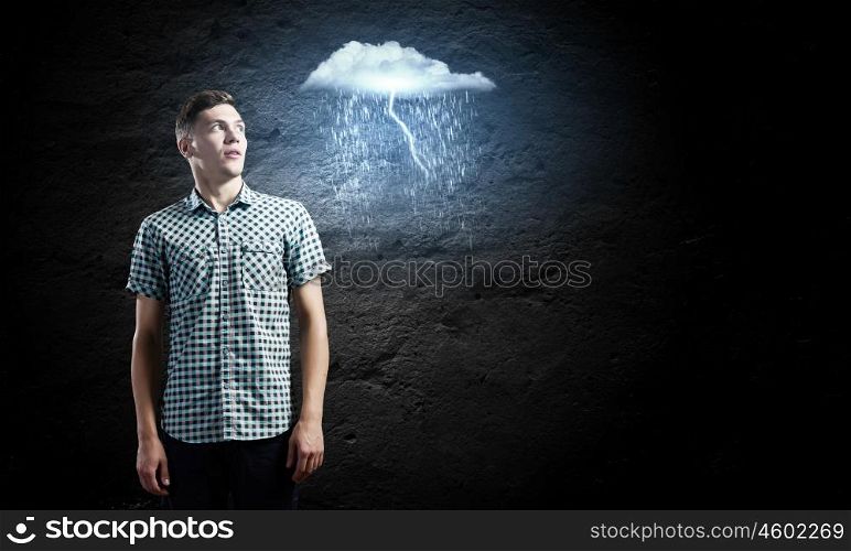 Let it rain. Young man looking at illustration of raining cloud