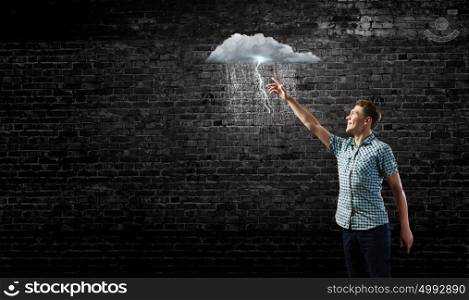 Let it rain. Young man touching illustration of raining cloud