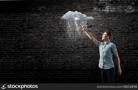 Let it rain. Young man touching illustration of raining cloud