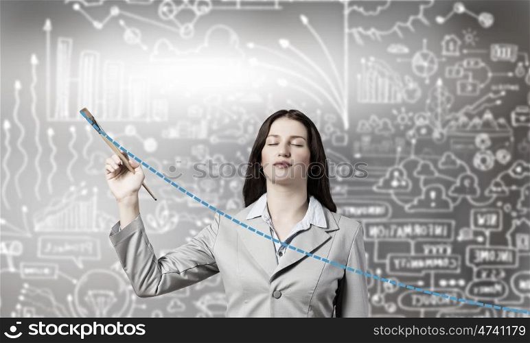 Let it your income go up. Young businesswoman drawing increasing graph with paint brush