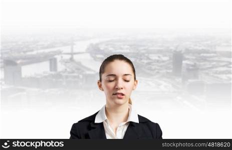 Let me think. Young businesswoman with closed eyes thinking something over
