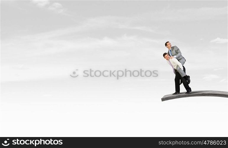 Let others work. Businessman riding on back of his colleague