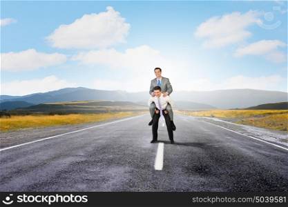 Let others work. Businessman riding on back of his colleague