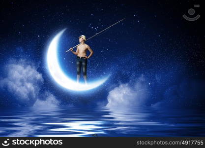 Let&rsquo;s go fishing. Boy of school age with fishing rod at night