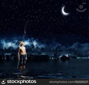 Let&rsquo;s go fishing. Boy of school age with fishing rod at night