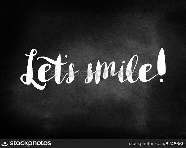 Let&rsquo;s smile written on a chalkboard
